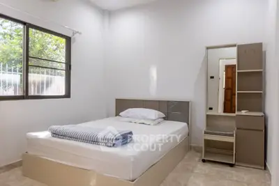 Cozy bedroom with natural light and modern furnishings, perfect for a peaceful retreat.