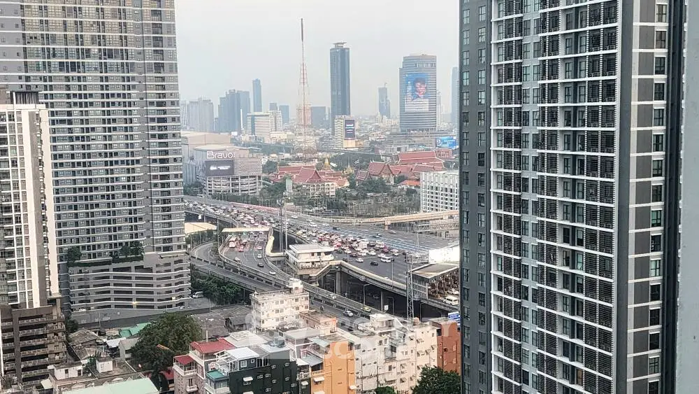 Stunning cityscape view from a high-rise building showcasing urban architecture and bustling traffic.