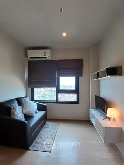 Cozy living room with city view, featuring a comfortable sofa and modern decor.