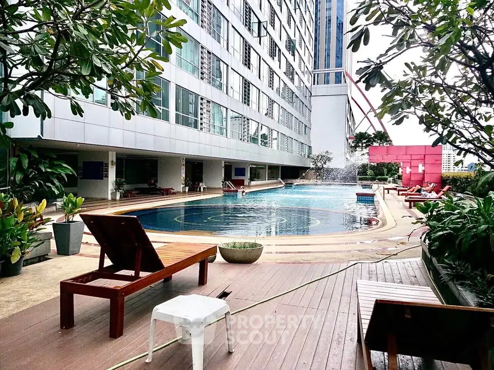 Luxurious apartment complex with a stunning outdoor pool and lush greenery, perfect for relaxation and leisure.