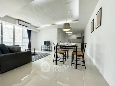 Modern open-plan living and dining area with sleek design and ample natural light.