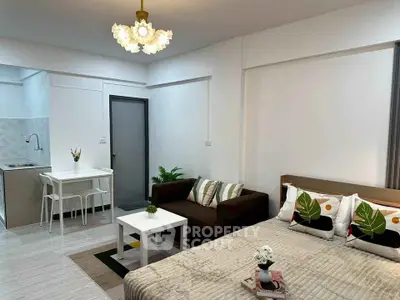 Modern studio apartment with cozy living area and compact kitchen