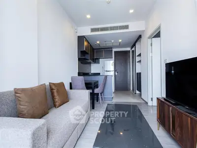 Modern living room with open kitchen layout and stylish furniture