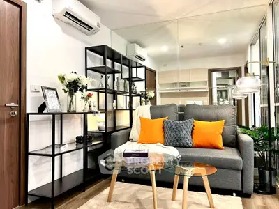 Modern living room with stylish decor, cozy sofa, and elegant glass coffee table.