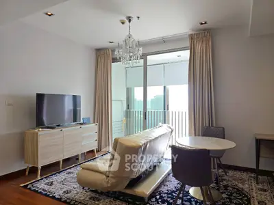 Modern living room with balcony and city view, featuring elegant chandelier and stylish furniture.