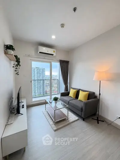 Modern living room with city view, featuring sleek furniture and bright decor.