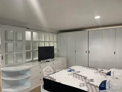 Spacious bedroom with modern furnishings and ample storage space