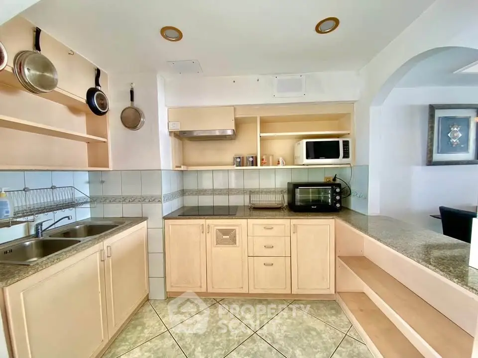 Spacious kitchen with modern appliances and open shelving