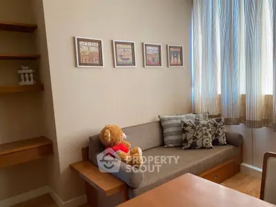 Cozy living room with plush sofa and decorative wall art, perfect for relaxation.