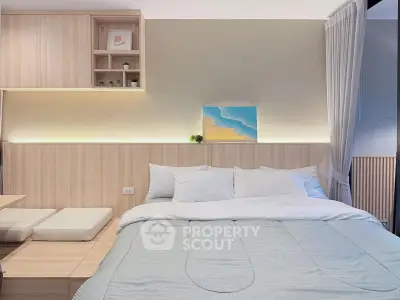 Modern bedroom with cozy bed and stylish wooden decor, perfect for relaxation and comfort.