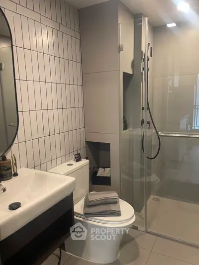 Modern bathroom with sleek design, glass shower, and stylish tiles