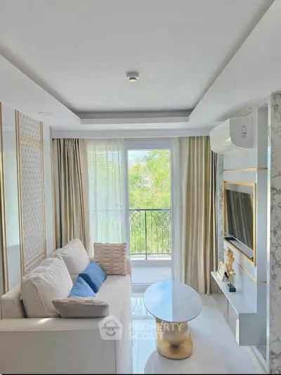 Luxurious living room with elegant decor and balcony view, featuring modern furniture and natural light.