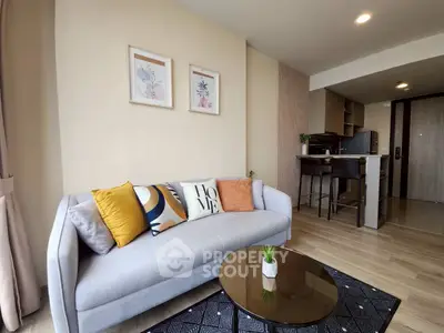 Modern living room with stylish decor and open kitchen layout in a cozy apartment.