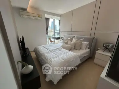 Modern bedroom with city view, featuring elegant decor and natural light, perfect for urban living.