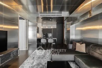 Modern living room with sleek metallic design and cozy seating area.