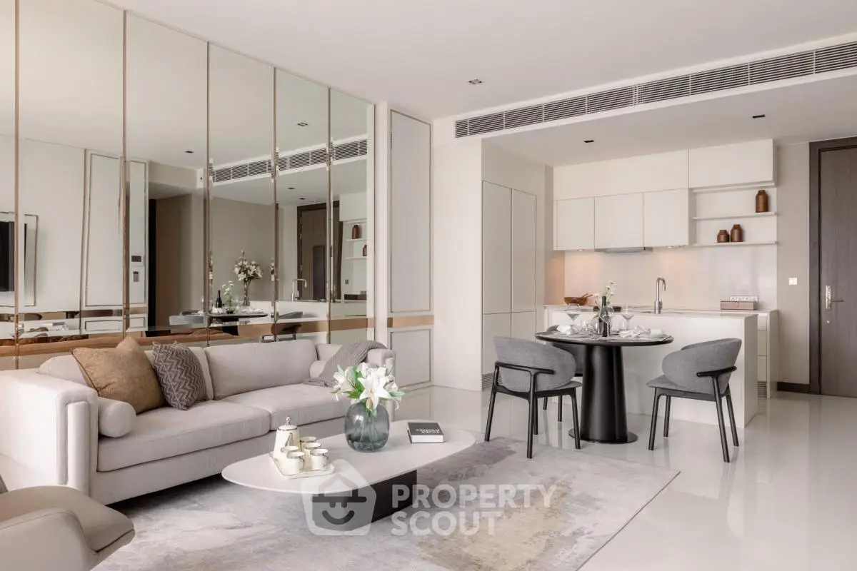 Luxurious modern living room with open kitchen, elegant decor, and stylish furniture in a contemporary apartment.