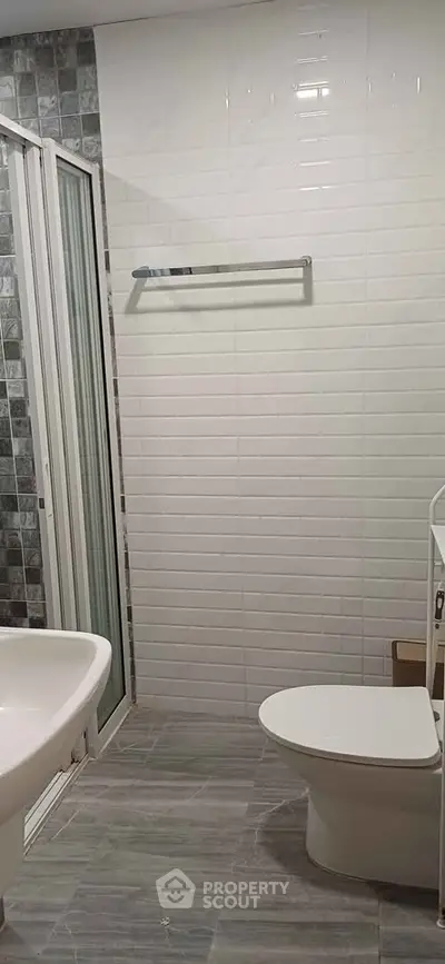 Modern bathroom with sleek white tiles and contemporary fixtures