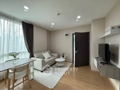 Modern living room with natural light, cozy seating, and stylish decor in a contemporary apartment.