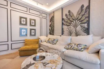 Stylish living room with elegant wall art and cozy seating in modern apartment.
