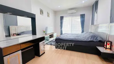 Spacious modern bedroom with stylish decor and natural light