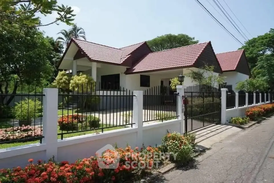 Charming suburban home with red-tiled roof and lush garden, perfect for family living.