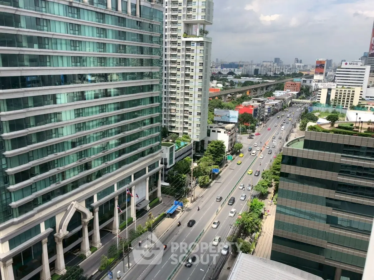Stunning urban view from high-rise building overlooking bustling cityscape and busy streets.