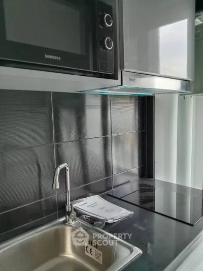 Modern kitchen with sleek stainless steel appliances and sink