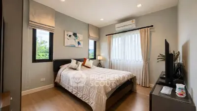 Modern bedroom with stylish decor, large windows, and air conditioning unit.