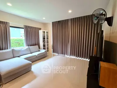 Spacious living room with modern sofa and large windows for natural light