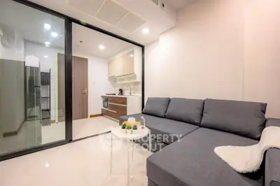 Modern living room with sleek furniture and open kitchen layout