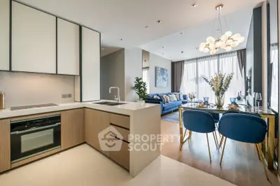 Modern open-plan kitchen and living room with stylish decor and natural light.
