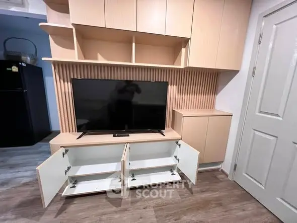Modern living room with sleek TV unit and ample storage space