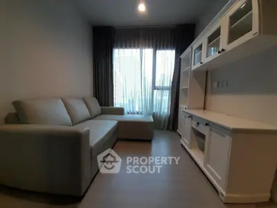 Cozy living room with modern sofa and stylish cabinetry, perfect for relaxation and entertainment.