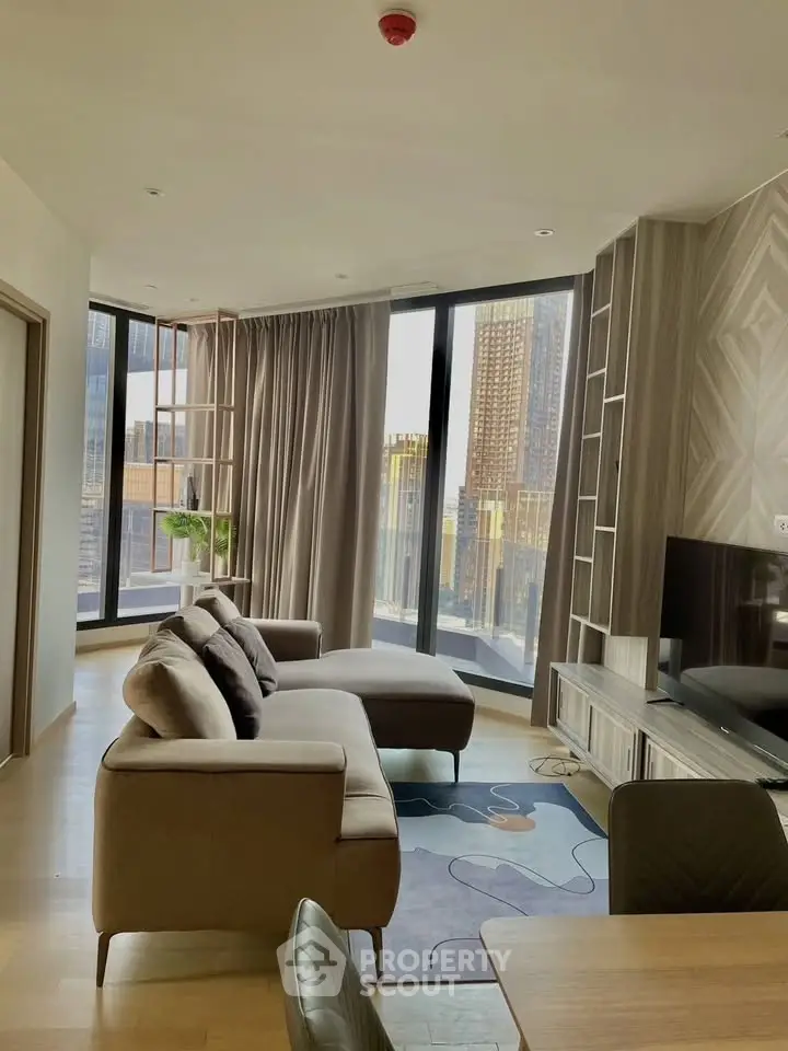 Modern living room with floor-to-ceiling windows and city view