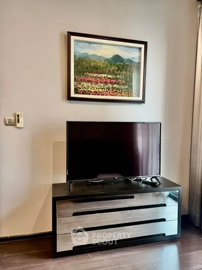 Modern living room with sleek TV stand and vibrant wall art