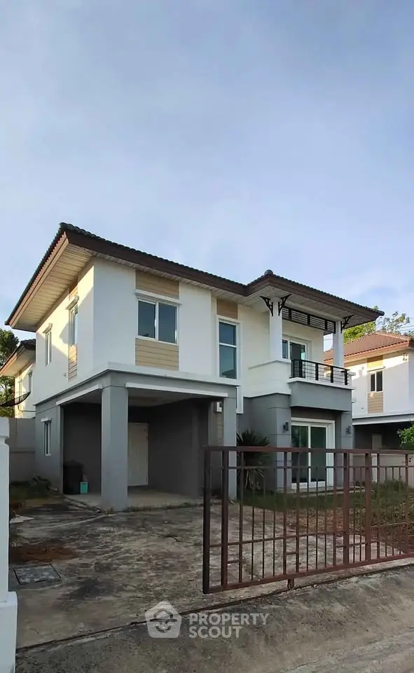 Modern two-story house with spacious driveway and contemporary design in a suburban neighborhood.