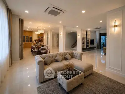 Luxurious open-plan living room with elegant decor and spacious dining area