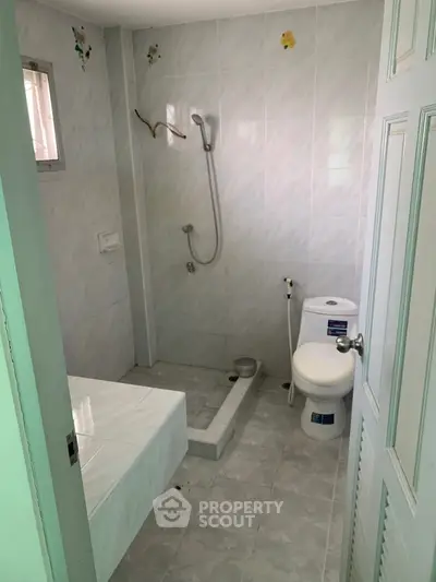 Compact bathroom with shower and toilet in minimalist design