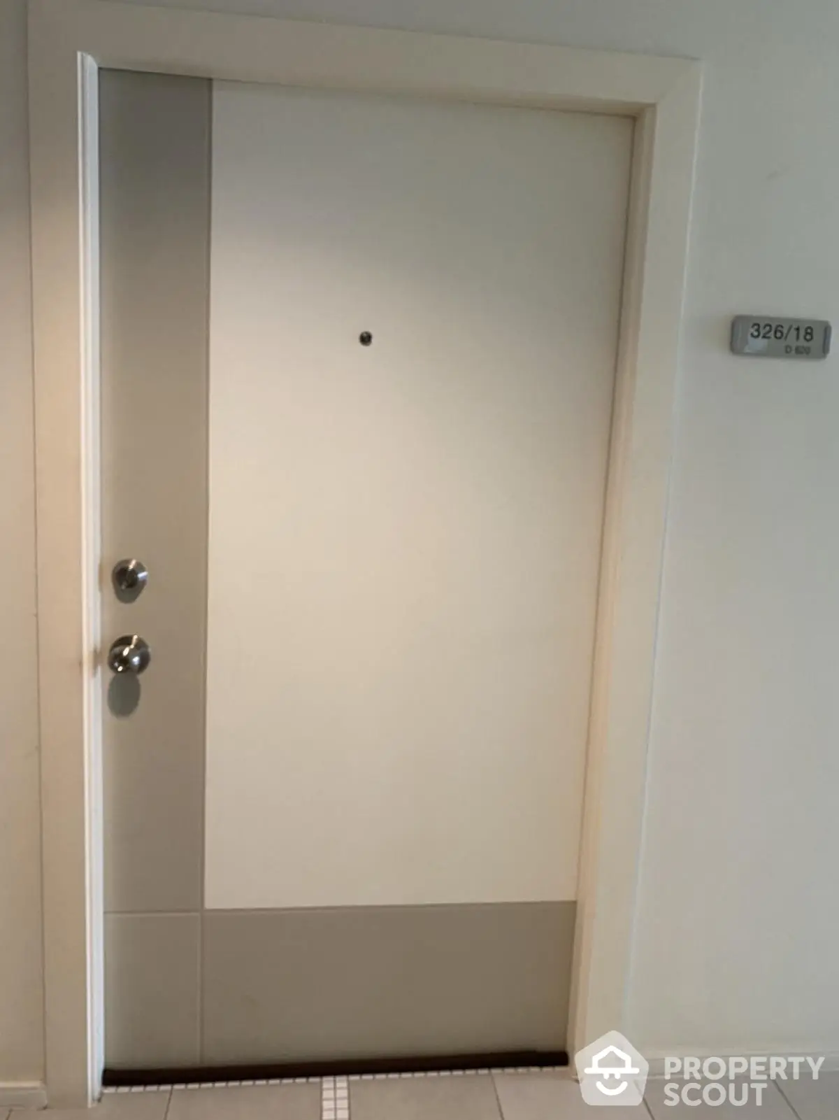 Modern apartment entrance door with sleek design and room number plaque.