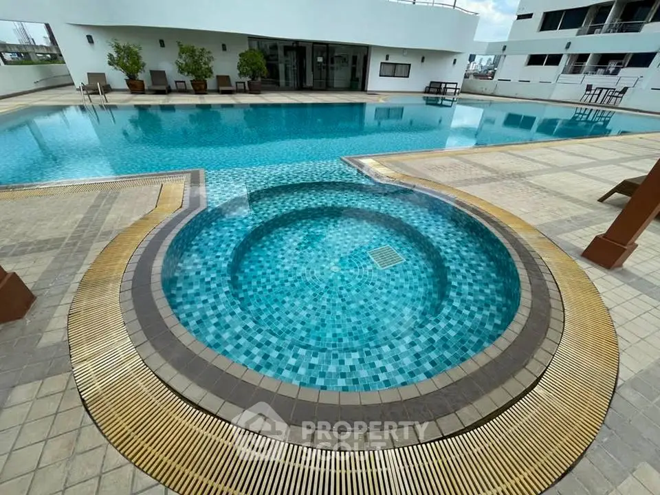 Luxurious rooftop pool with jacuzzi in modern apartment complex