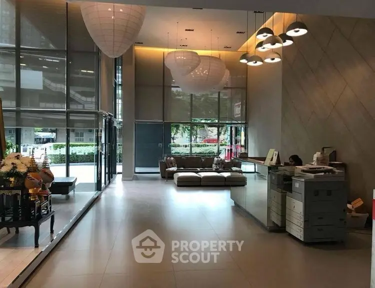 Luxurious modern building lobby with stylish lighting and spacious seating area.