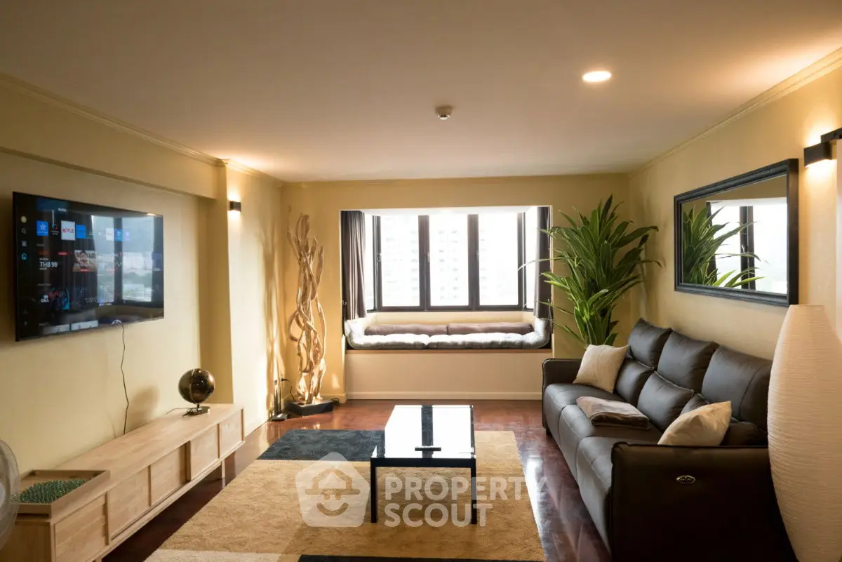 Spacious living room with modern decor and large window view