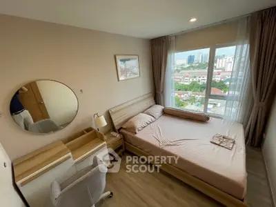 Cozy bedroom with city view, featuring a comfortable bed, stylish furniture, and large window for natural light.