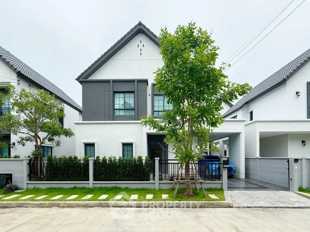 Modern two-story house with a sleek design, manicured lawn, and spacious driveway in a suburban neighborhood.