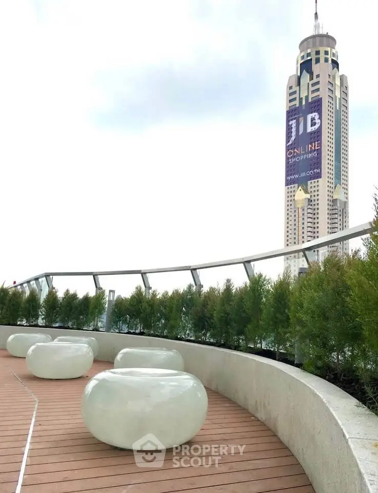 Stunning rooftop terrace with modern seating and city skyline view, perfect for urban living.