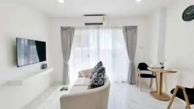 Modern living room with sleek design, featuring a cozy sofa, wall-mounted TV, and elegant dining area.