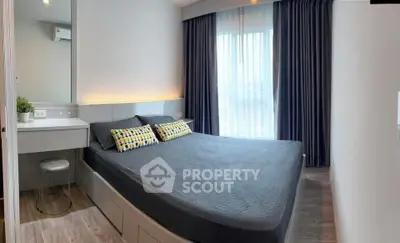 Modern bedroom with stylish decor and large window for natural light.