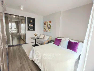 Modern bedroom with stylish decor and cozy seating area, perfect for relaxation and comfort.