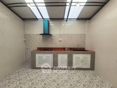 Modern kitchen with sleek design and gas stove, featuring ample counter space and stylish backsplash.