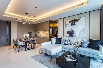 Luxurious modern living room with open kitchen, elegant decor, and stylish furniture in a high-end apartment.